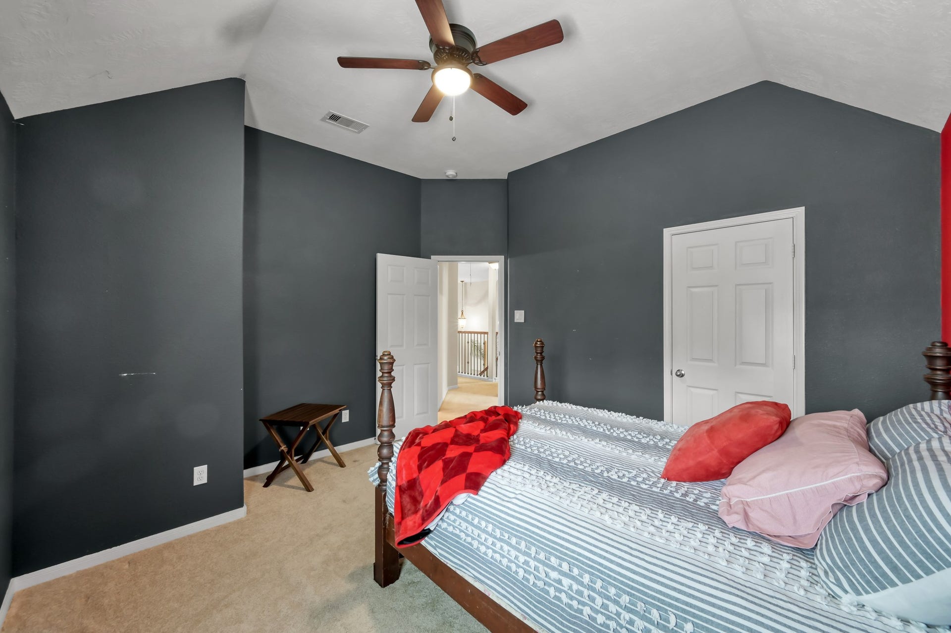 2502 Wynden Meadow Lane, Conroe, TX 77304 Another look at this stylish bedroom showcasing dramatic accent walls, vaulted ceilings, and a comfortable, inviting atmosphere.