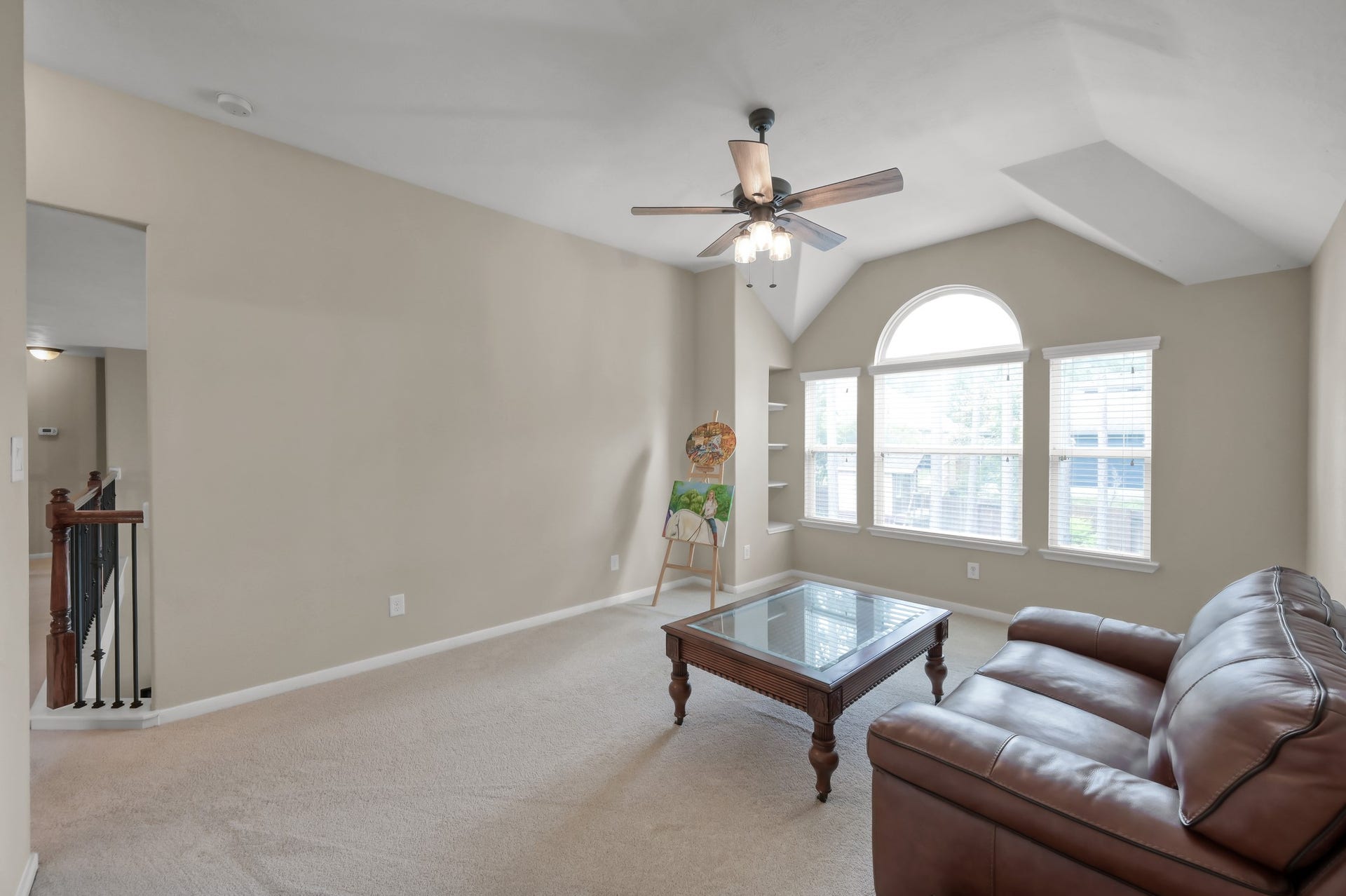 2502 Wynden Meadow Lane, Conroe, TX 77304 Versatile upstairs living area perfect for a game room, media space, home office, or playroom with beautiful natural light and vaulted ceilings.