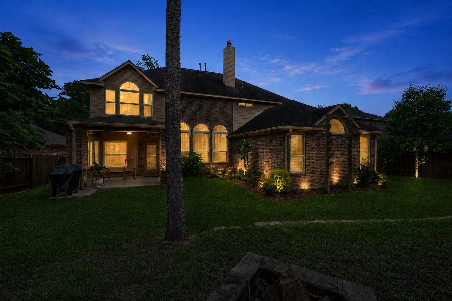 2502 Wynden Meadow Lane, Conroe, TX 77304 Beautifully maintained backyard with mature landscaping, wide open green space, and peaceful wooded surroundings that create a private outdoor retreat.