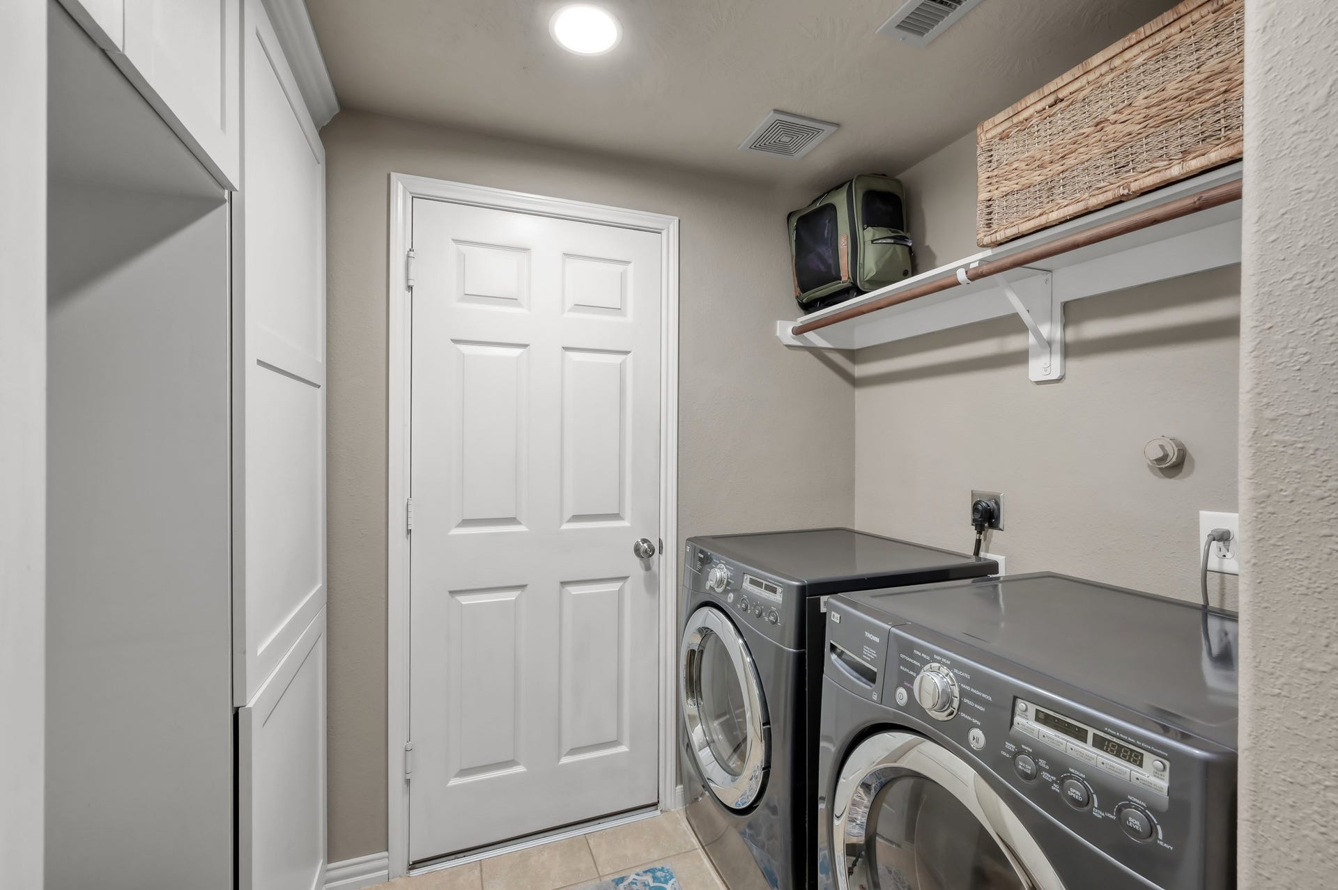 2502 Wynden Meadow Lane, Conroe, TX 77304 Functional laundry room with built-in storage, shelving, and space to keep everything organized and convenient.