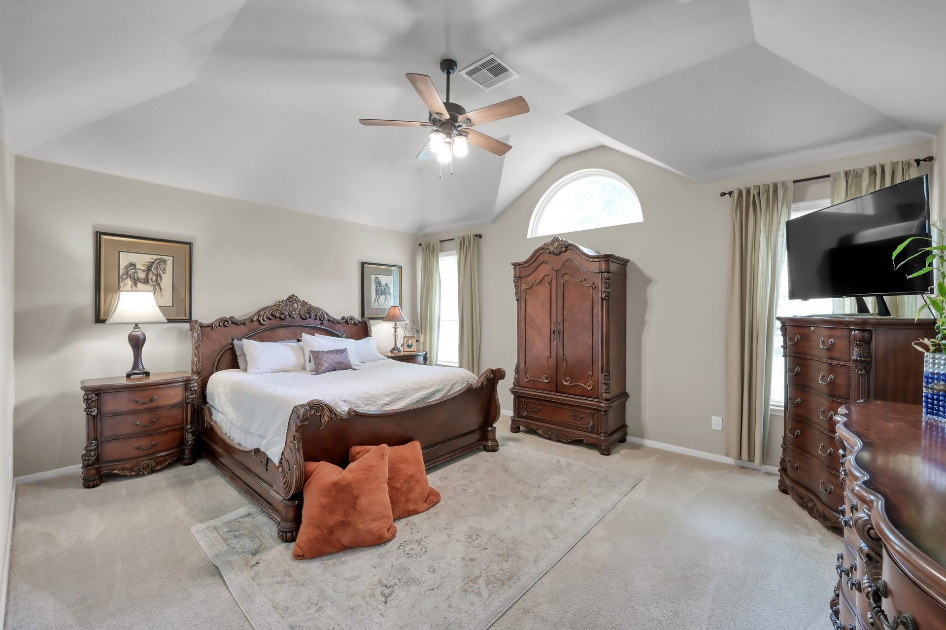 2502 Wynden Meadow Lane, Conroe, TX 77304 This oversized primary bedroom features elegant architectural ceilings, large windows, and a bright, airy layout designed for comfort and relaxation.