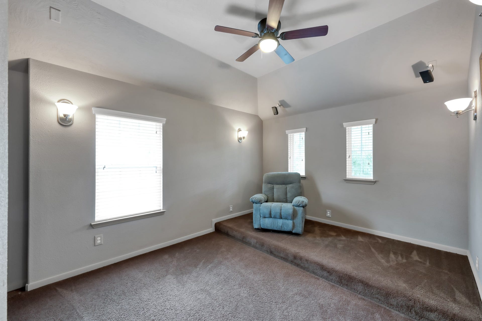 2502 Wynden Meadow Lane, Conroe, TX 77304 Private media room with raised viewing area and surround sound setup, creating the perfect space for a home cinema experience.
