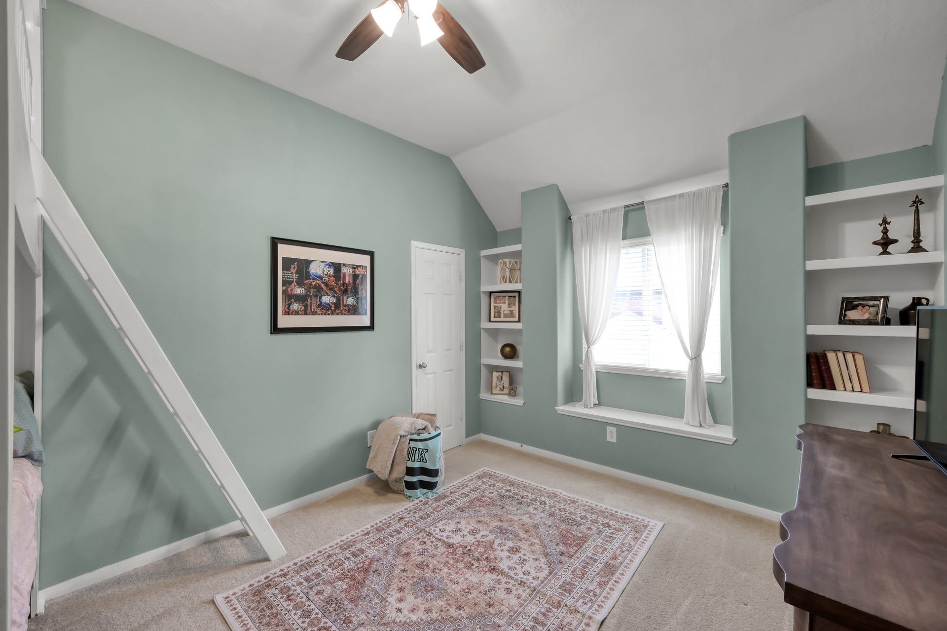 2502 Wynden Meadow Lane, Conroe, TX 77304 Spacious bedroom with soaring ceilings, built-in shelving, window seating, and unique architectural details that give the space extra character.