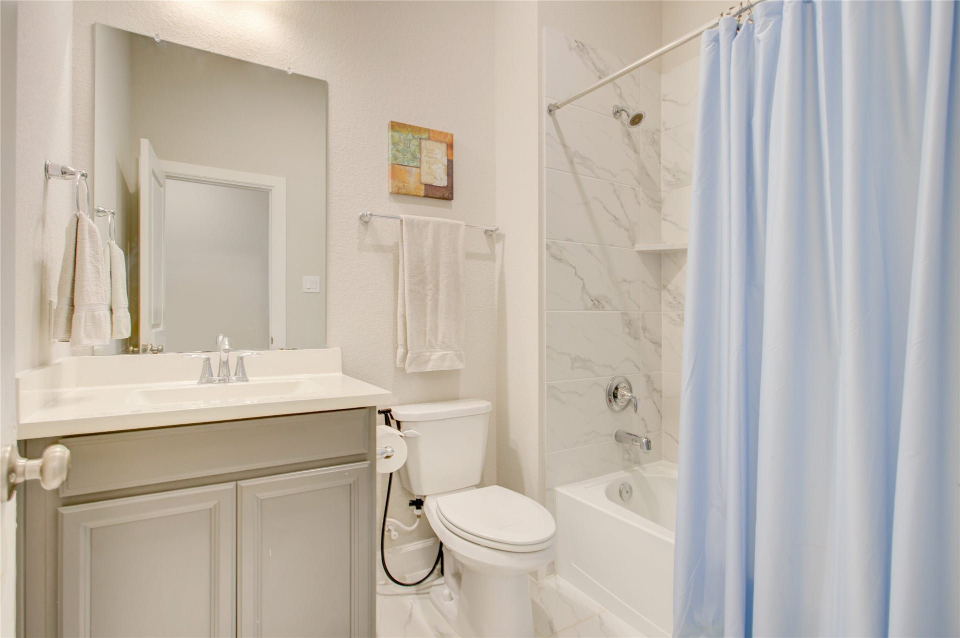 3423 Tranquil Harvest Trail, Richmond, TX 77406 Bathroom with a single vanity, large mirror, toilet, and tub/shower combination with tiled surround.