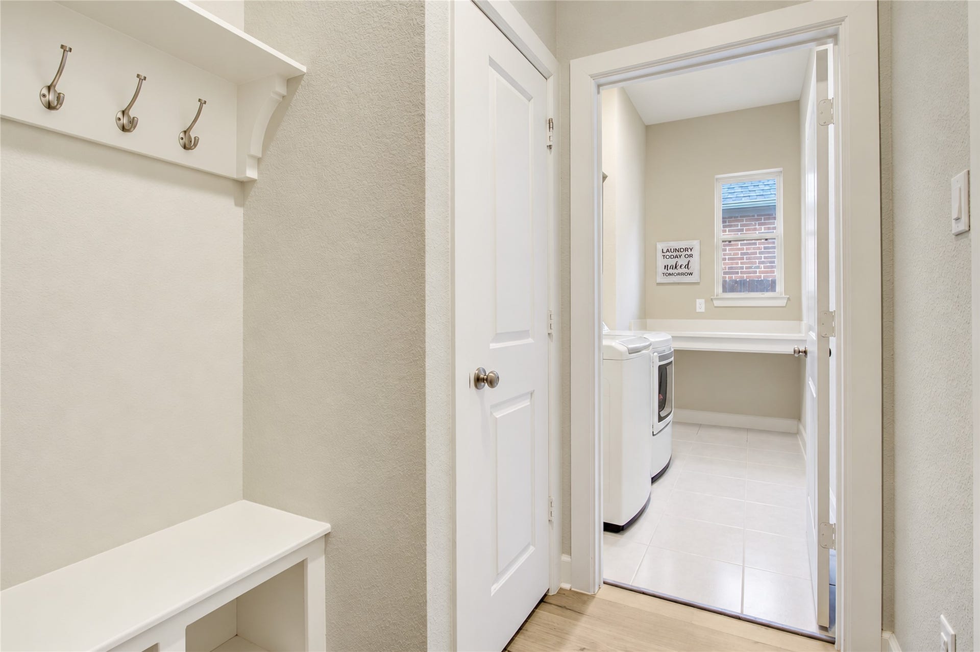 3423 Tranquil Harvest Trail, Richmond, TX 77406 Laundry room with washer and dryer, tiled flooring, a window, and built-in folding table.