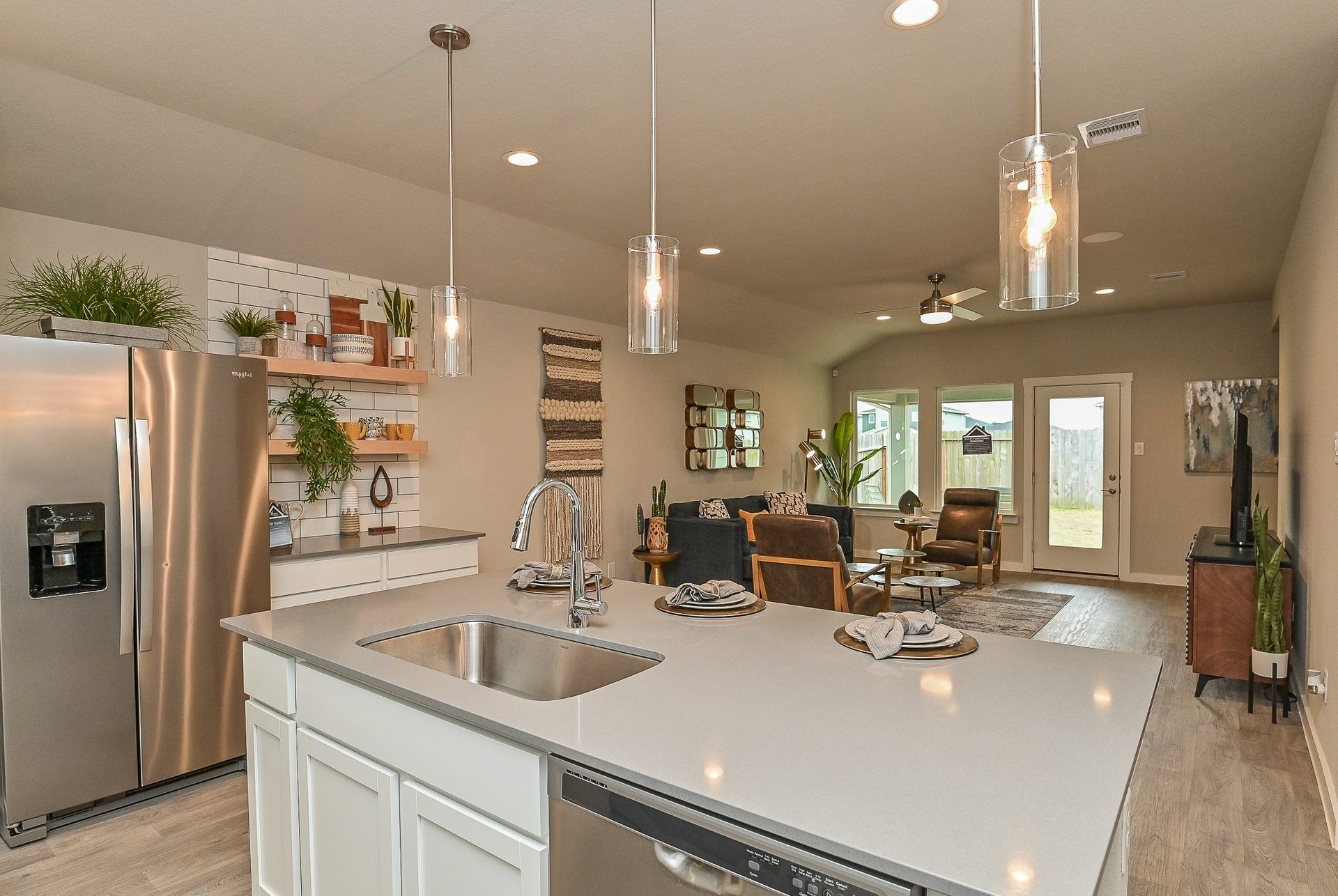 View from the kitchen into the living area; great lighting all around. ***Photo of furnished model***
