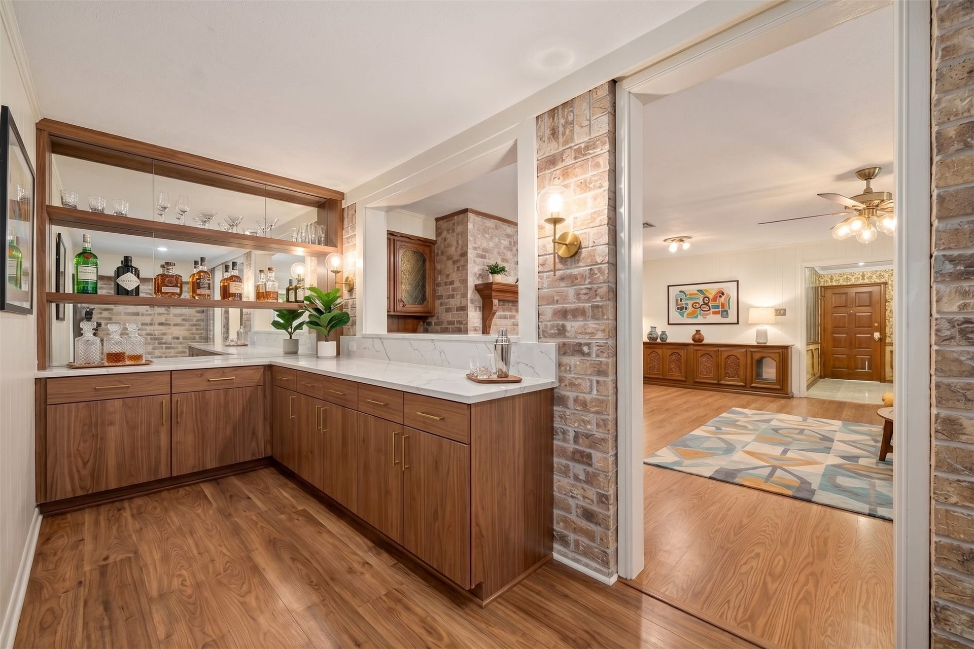 Virtually enhanced wetbar area featuring custom cabinetry, premium quartz countertops, and integrated wine storage. Perfect for seamless entertaining, this sophisticated space is designed to elevate your hosting experience.