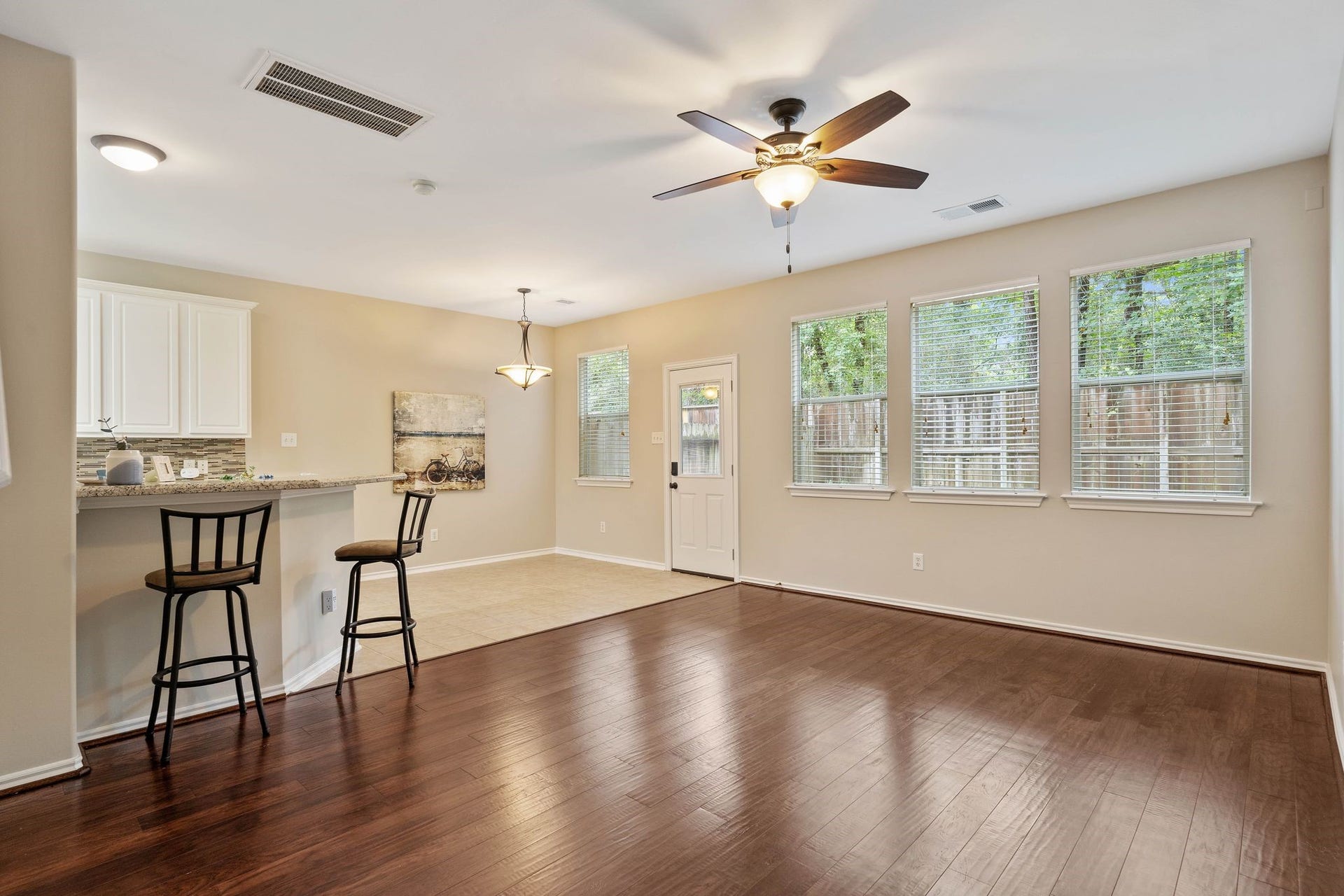 50 Leafstalk Court, The Woodlands, TX 77382 beautiful hardwood floors, freshly painted interiors, brand new HVAC system, windows included blinds, backyard is fully fenced (now has new fence) and the unit sits on the end with woods and greenbelt surrounding