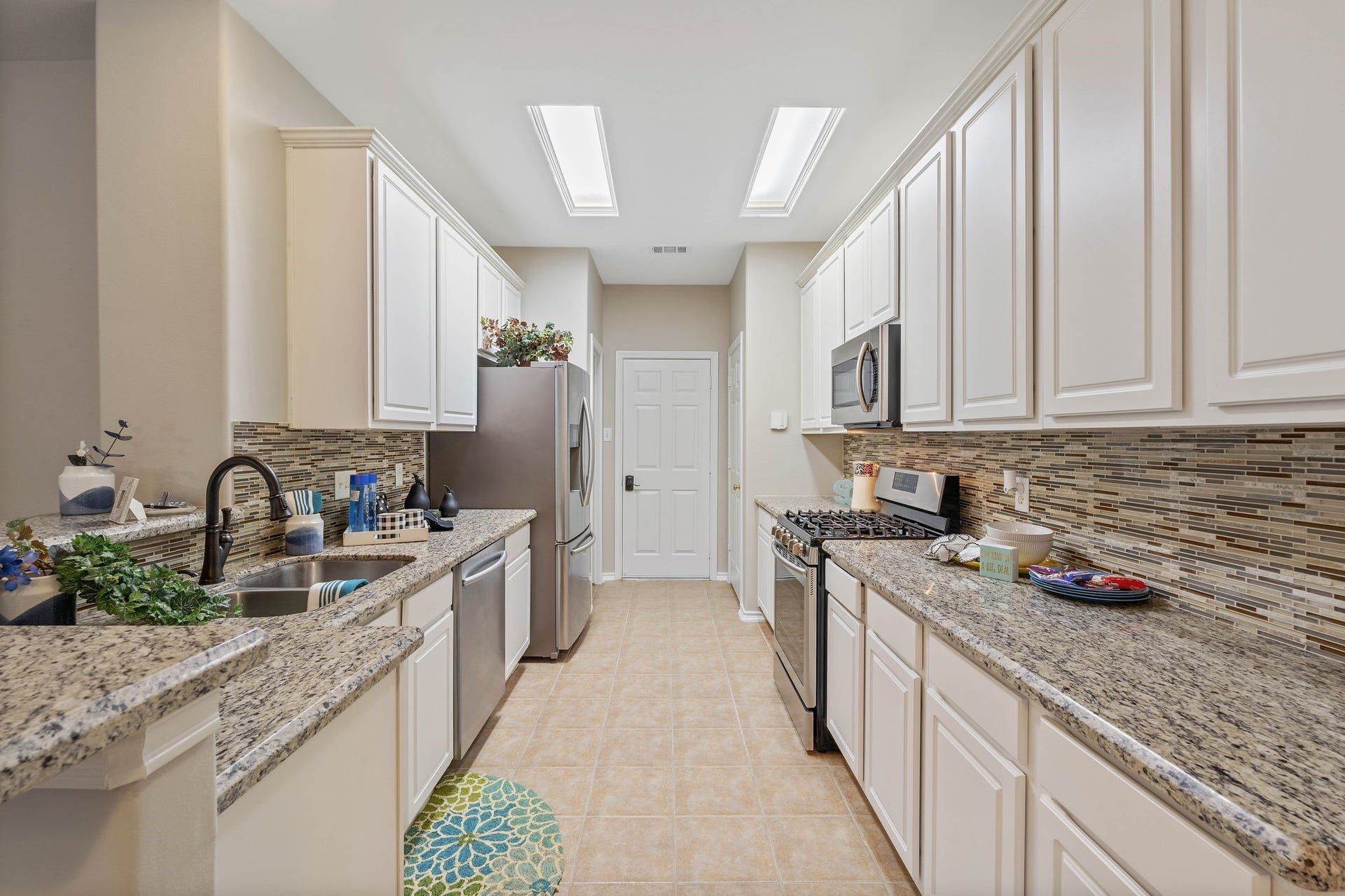 50 Leafstalk Court, The Woodlands, TX 77382 upgraded granite and stainless kitchen, appliance included, walk-in pantry, exit to your 2-car detached garage, gas cooktop, open concept to living area