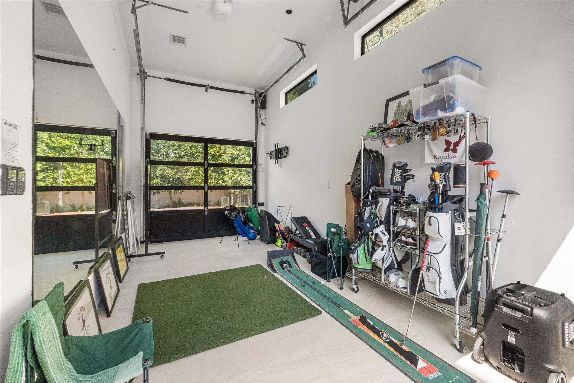 2608 Barbara Lane, Houston, TX 77005 This extended one-car garage offers versatility, opening on both sides to capture views of the sparkling pool. Currently outfitted for sports equipment, this space provides endless possibilities for recreation, storage, car parking, or a private poolside retreat.