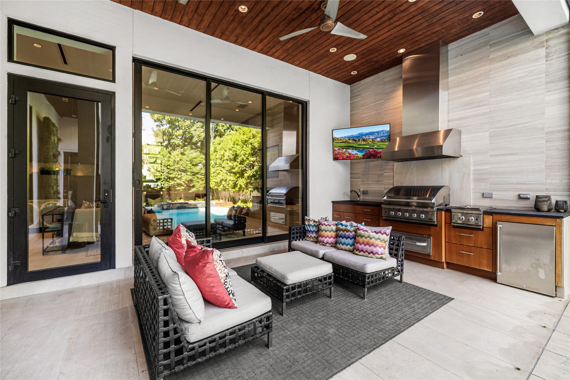 2608 Barbara Lane, Houston, TX 77005 Step outside to an exceptional covered outdoor kitchen, impeccably appointed with a vented grill hood, sink, and beverage fridge. Designed for elevated entertaining, this sophisticated outdoor living space offers a seamless extension of the home for memorable gatherings and effortless poolside hosting.
