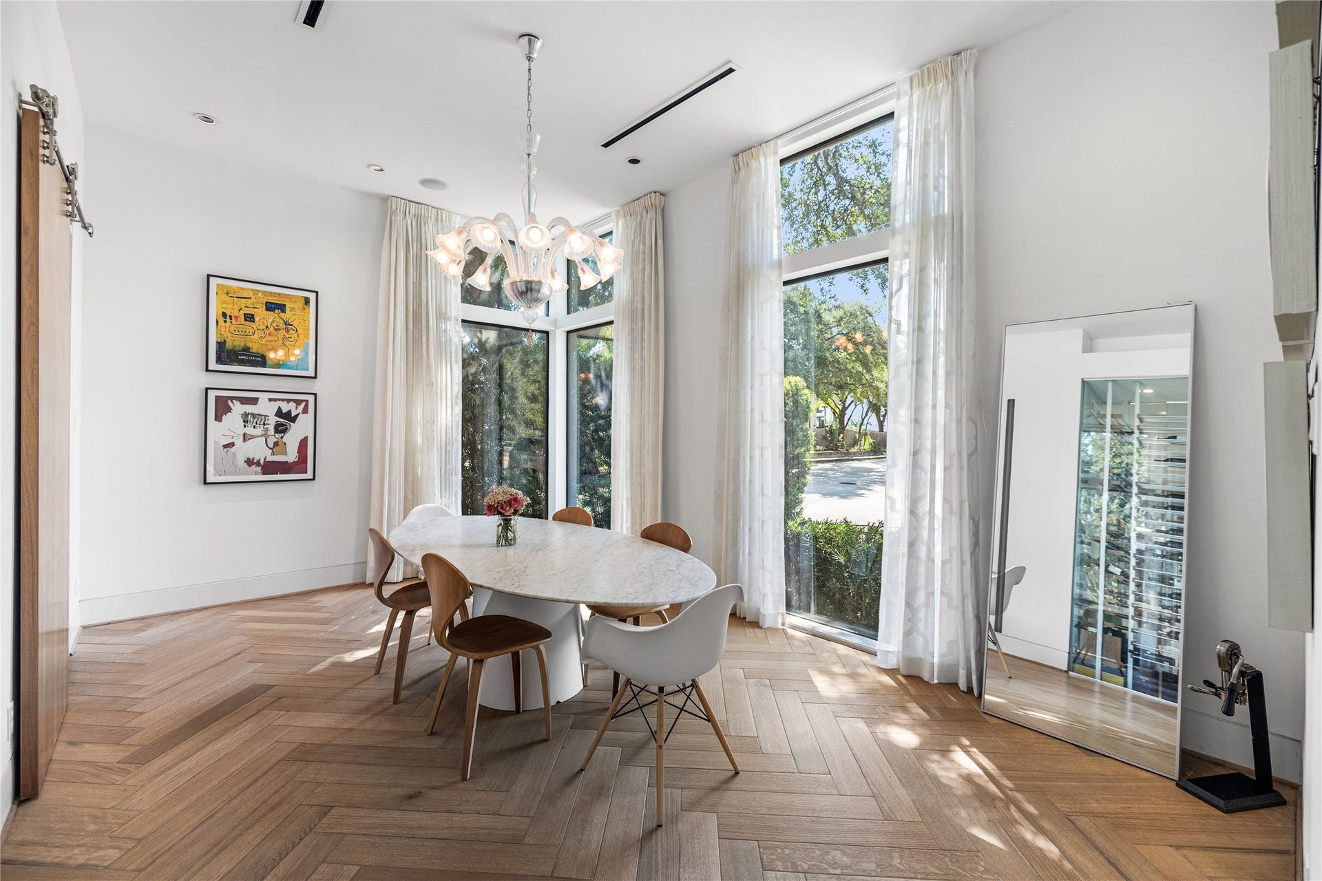 2608 Barbara Lane, Houston, TX 77005 High ceilings, herringbone floors, and floor-to-ceiling windows give the formal dining room an old-world European grace. A heavy sliding door offers privacy from the kitchen, and this room comfortably fits a much larger, expandable table for grand-scale entertaining.