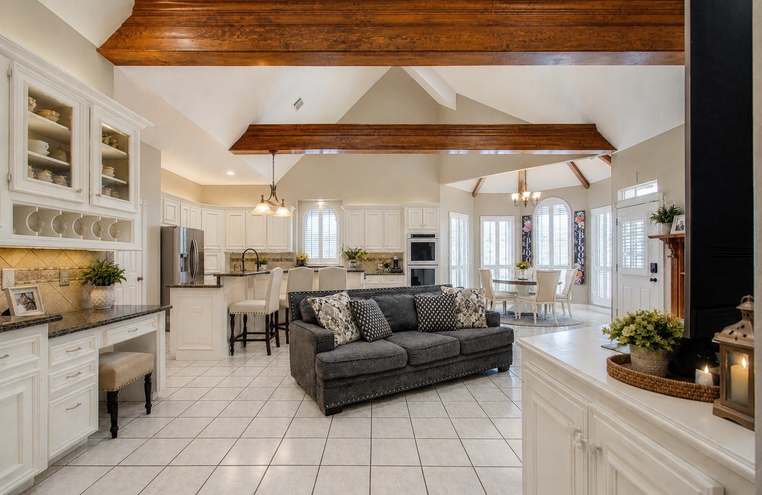 Family room / kitchen area is beautiful showcasing beautiful beams and vaulted ceilings.  In person they are amazing
