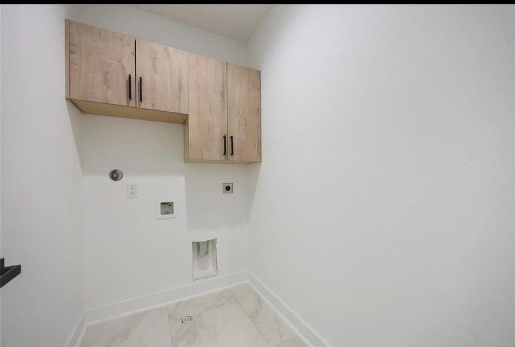 7920 Boy Street, #B, Houston, TX 77028 Dedicated laundry area featuring built-in cabinetry and convenient washer and dryer connections.