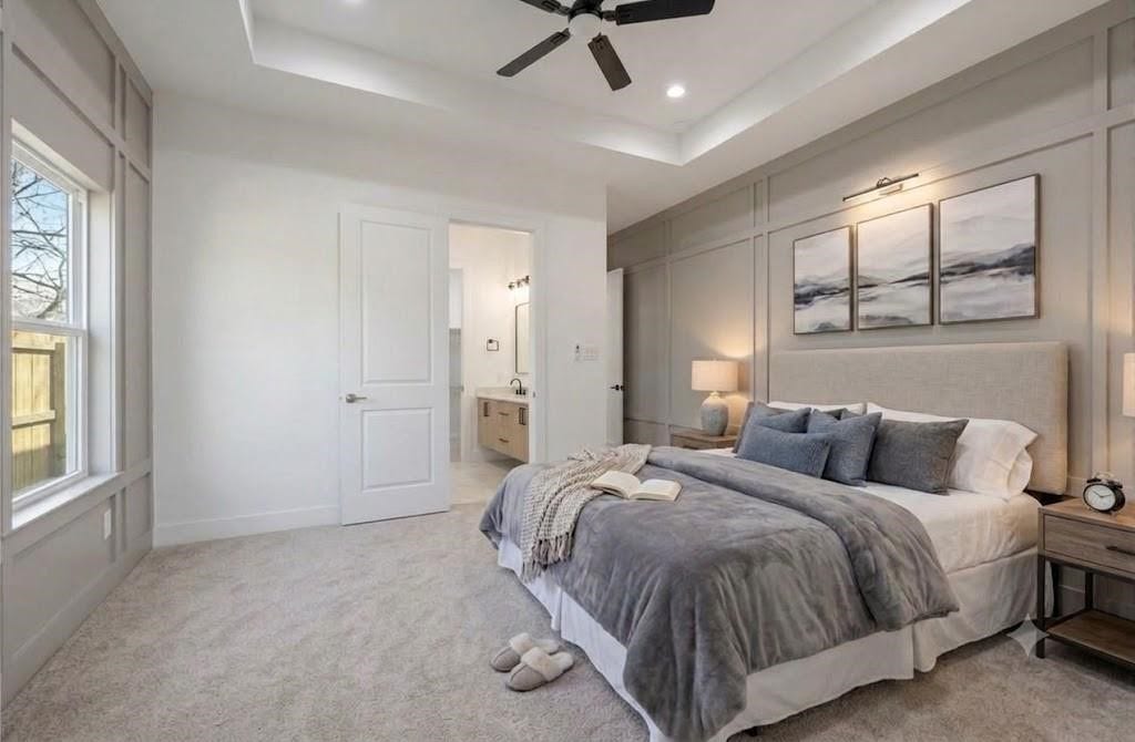 7920 Boy Street, #B, Houston, TX 77028 Spacious primary bedroom featuring high ceilings, a ceiling fan, and large windows that welcome natural light.