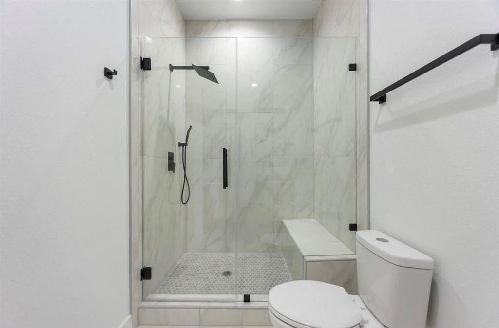 7920 Boy Street, #B, Houston, TX 77028 Contemporary bathroom featuring a glass-enclosed shower, modern fixtures, and elegant tile finishes.
