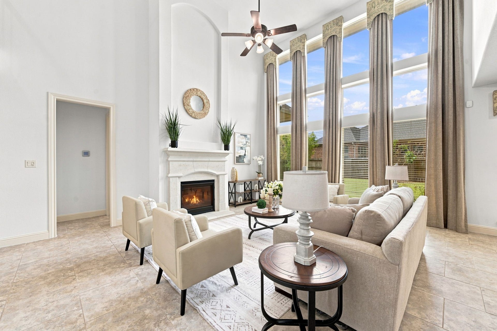 Bright, airy and spacious living room with floor-to-ceiling windows overlooking the backyard.