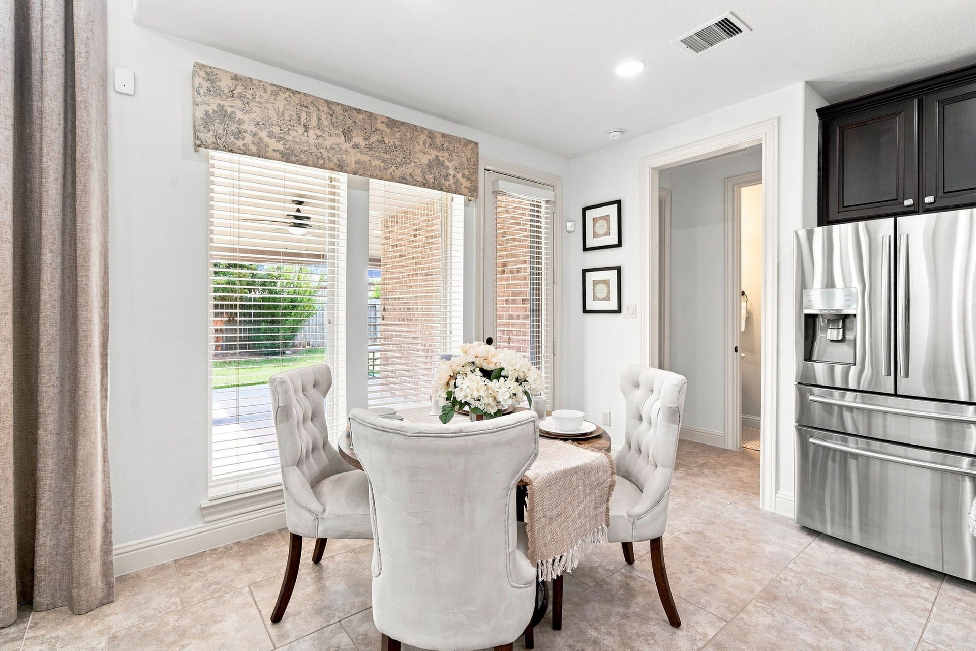 Charming breakfast nook bathed in natural light, offering the perfect spot for morning coffee with a view of the backyard.