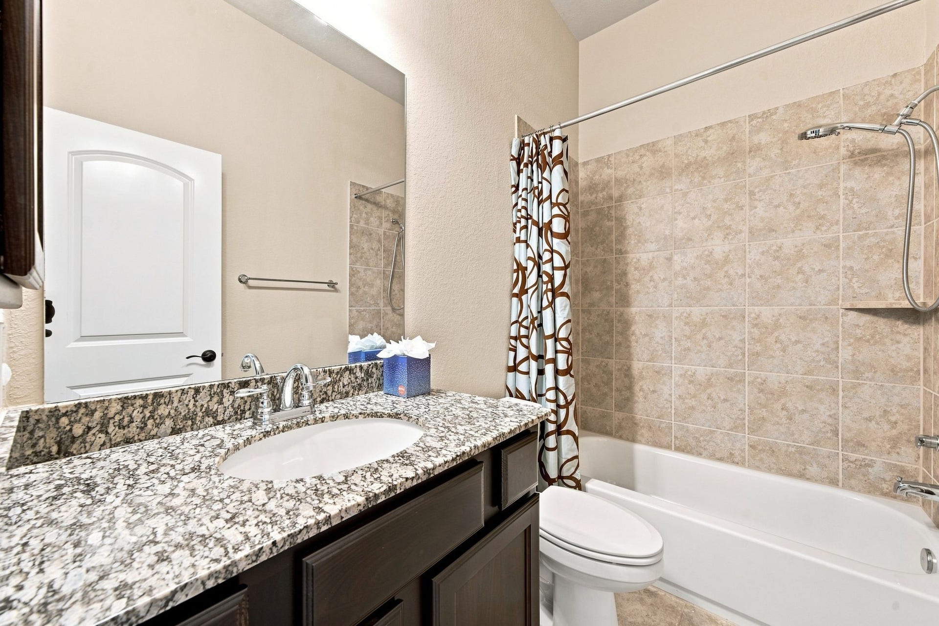 Well-appointed bathroom with a granite vanity and a tub/shower combination designed to fit comfortably into your daily lifestyle.