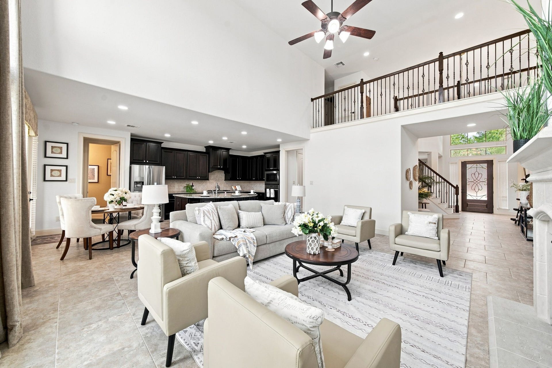 Impressive open-concept living space with valuated ceilings, flows seamlessly into the kitchen and breakfast area.
