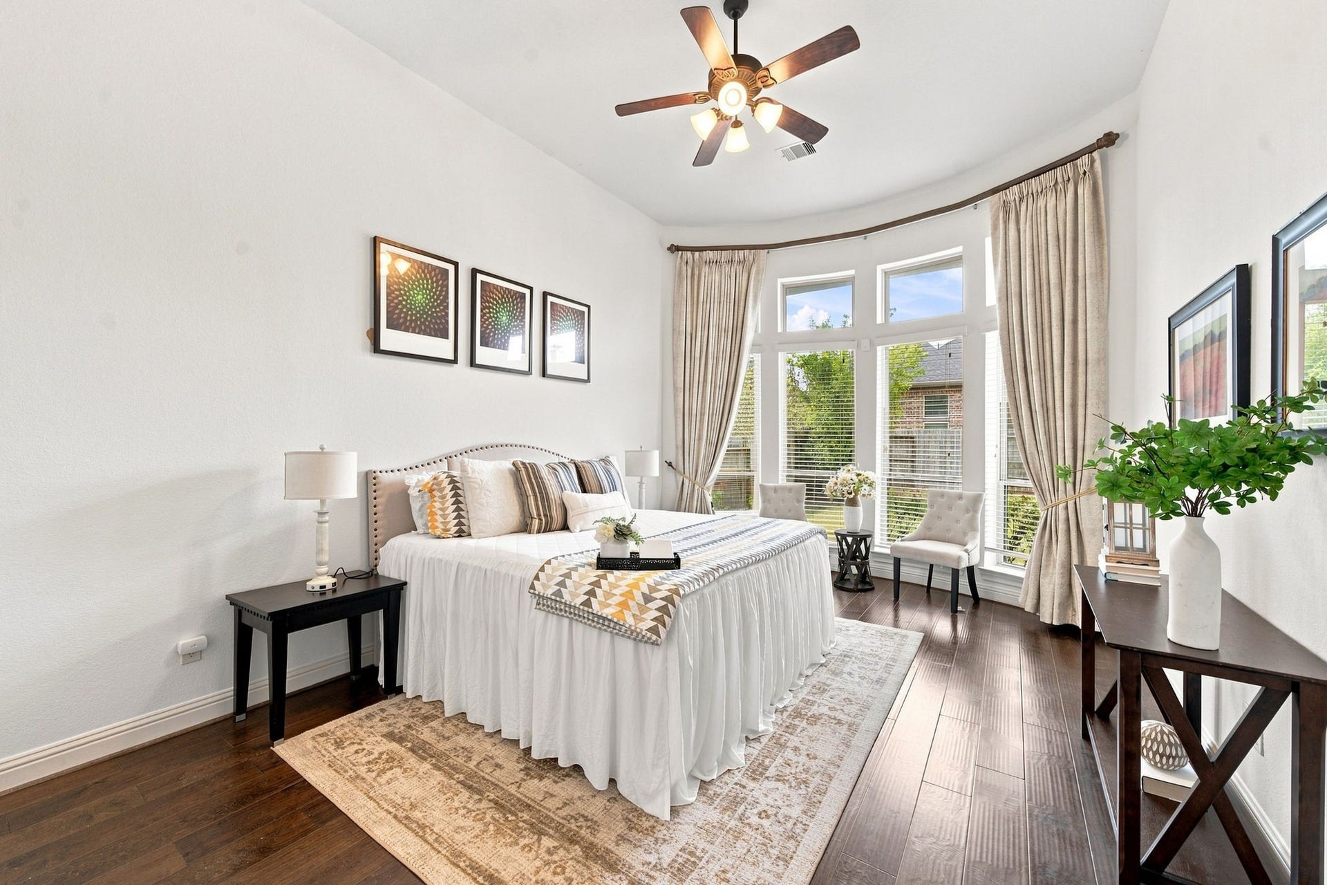 Welcome to your own private and spacious retreat with a curved wall of windows, a cozy sitting nook, and rich wood flooring throughout.