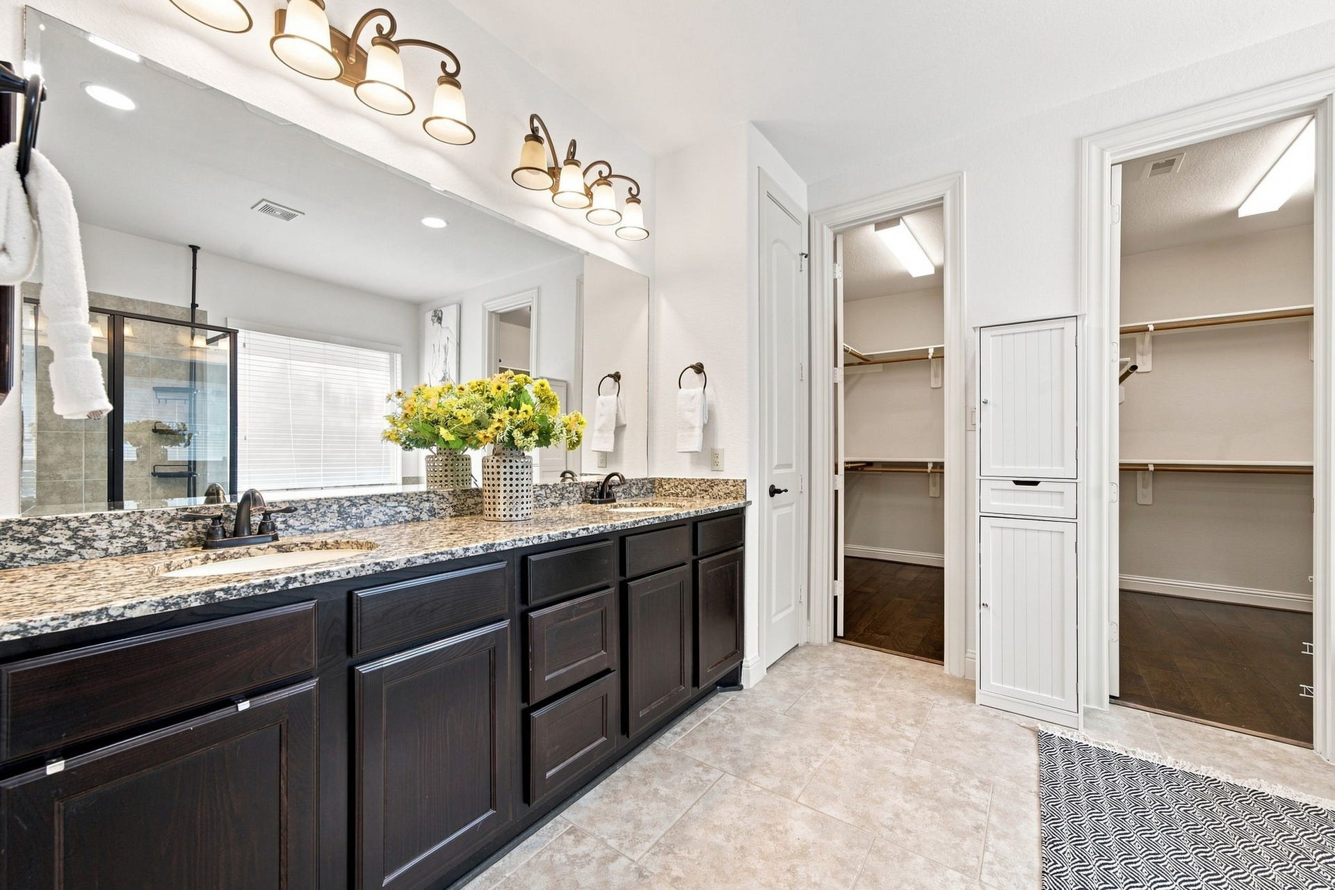 This primary path has upgraded dual sink vanity with granite counter and 2 spacious walk-in closets