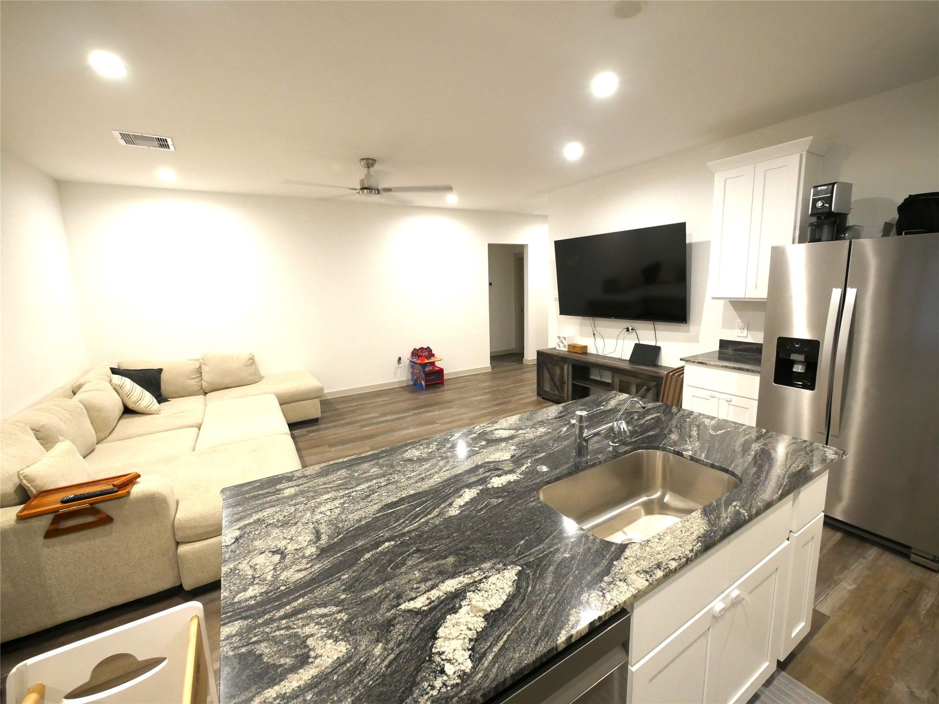 Beautifully appointed kitchen featuring a large island, gas range, ample cabinetry, and an open design ideal for everyday living and entertaining.