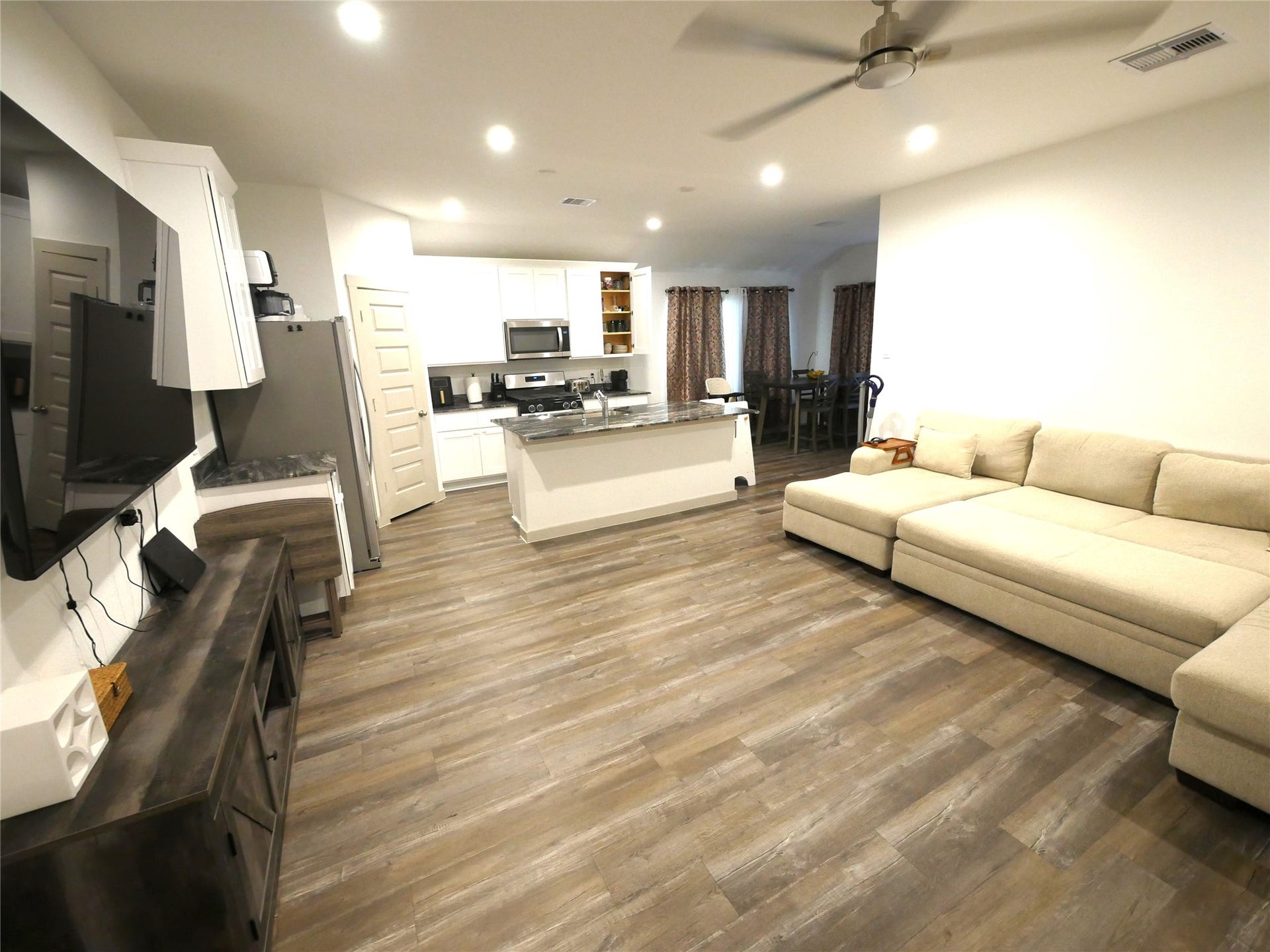 Open-concept living area featuring abundant natural light, modern finishes, and a spacious layout that flows seamlessly into the kitchen and dining areas.