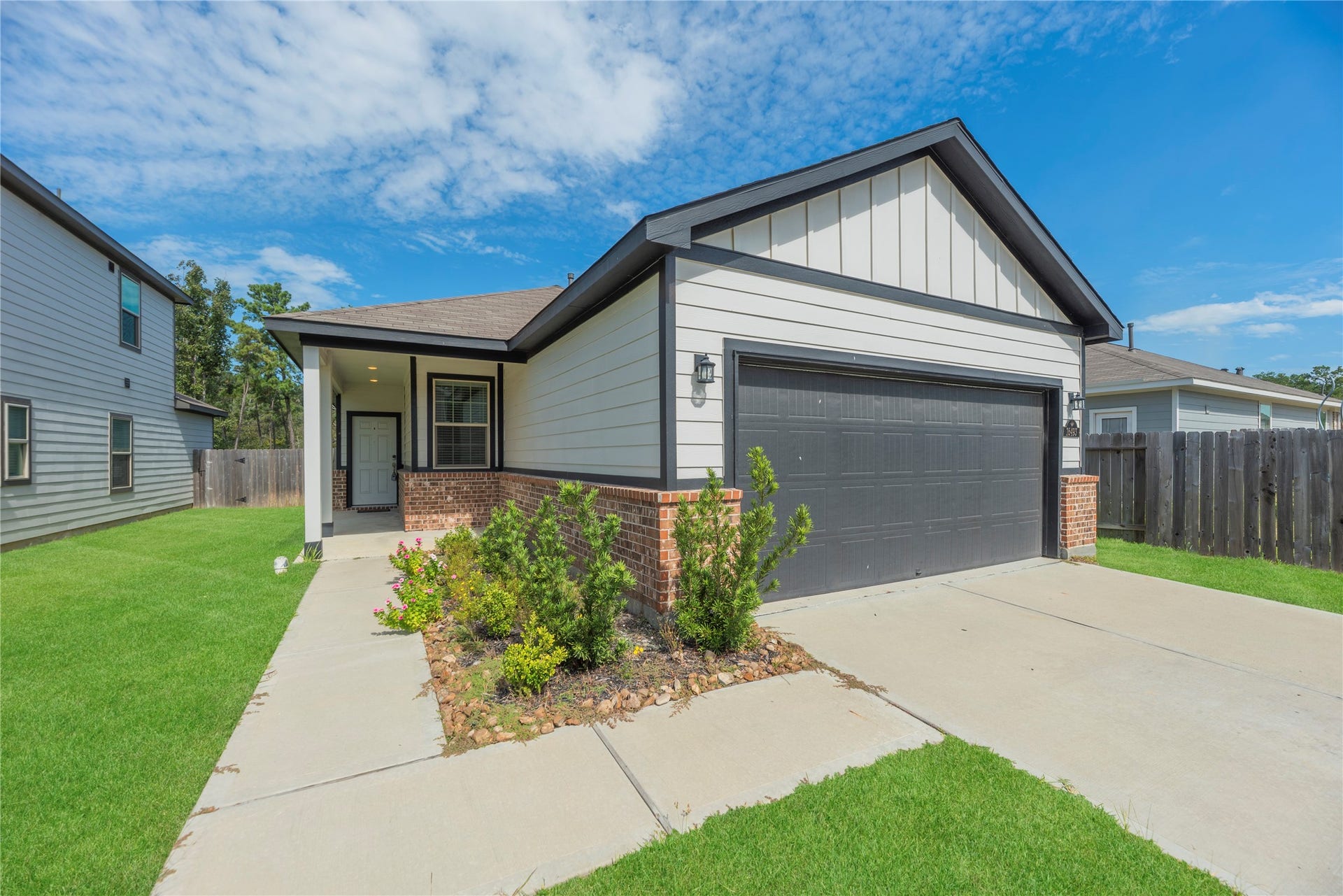 16493 Moss Lane, Porter, TX 77365 The sheltered entry offers a comfortable spot to arrive home, while contrasting trim and brick accents add character to the front exterior.
