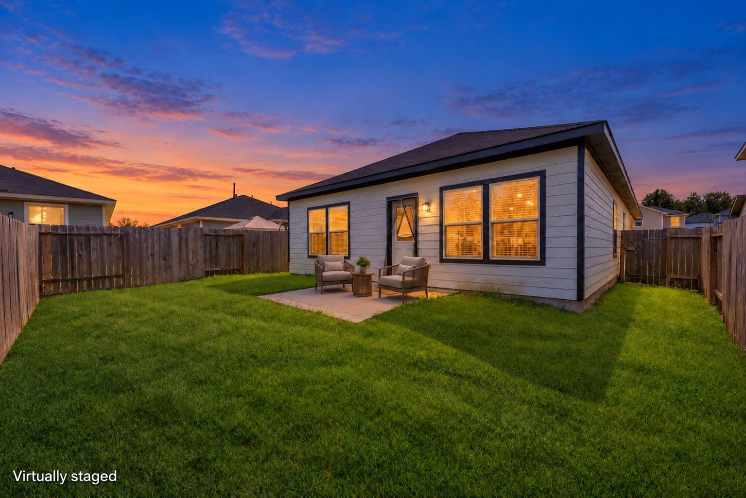 16493 Moss Lane, Porter, TX 77365 Imagine winding down on the patio with a pair of comfortable chairs overlooking the fenced lawn. Outdoor furniture is virtually staged and twilight lighting is digitally enhanced; daytime original included.