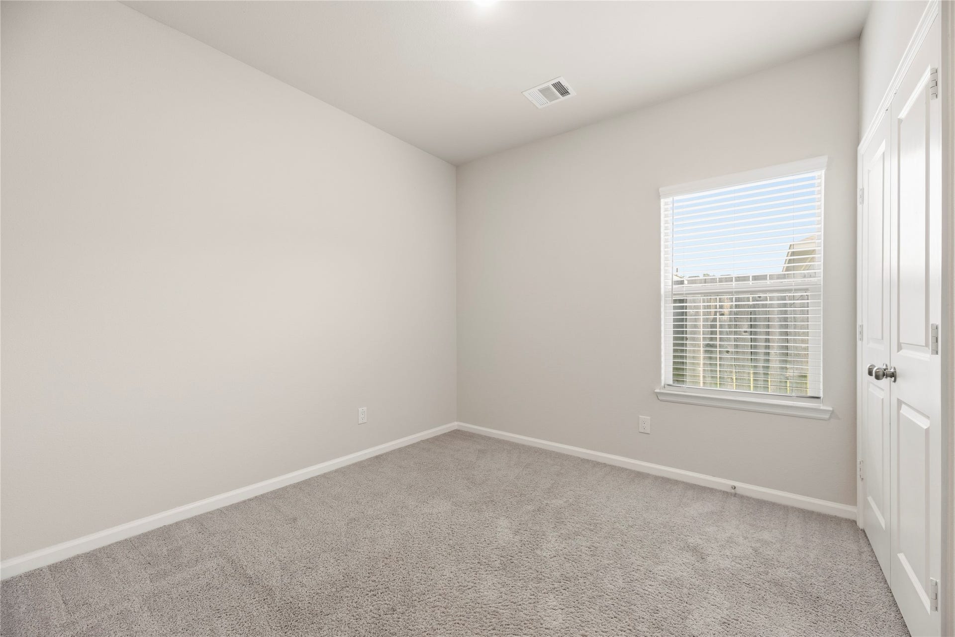 16493 Moss Lane, Porter, TX 77365 This additional bedroom offers a neutral backdrop and carpeted comfort, with closet storage and a window bringing in natural light.