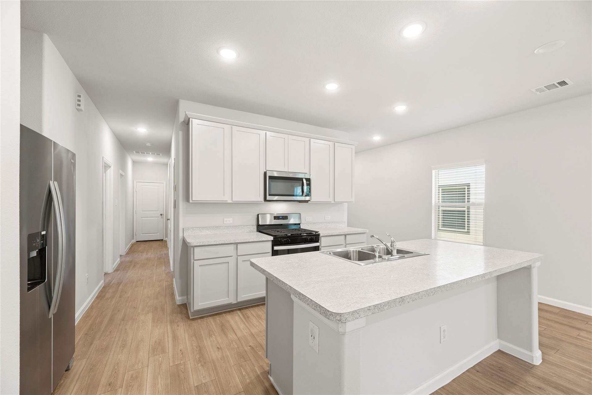 16493 Moss Lane, Porter, TX 77365 The island anchors the kitchen with a sink and dishwasher close at hand, bringing meal preparation and cleanup together in one convenient workspace.
