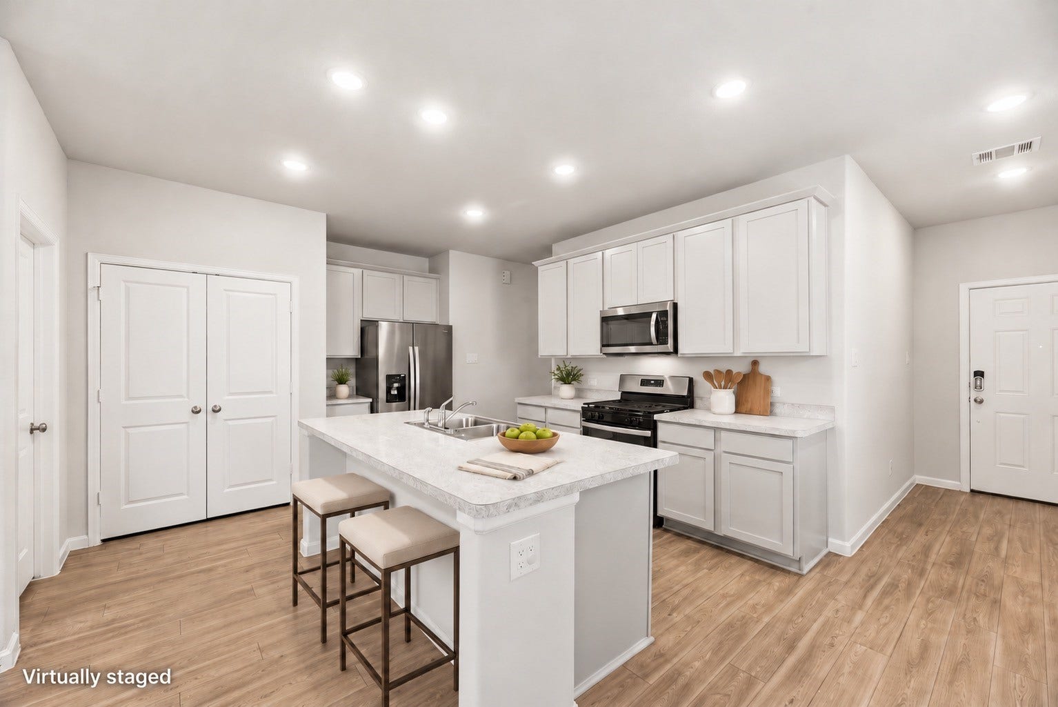 16493 Moss Lane, Porter, TX 77365 A few thoughtful touches show how the island can serve as an everyday gathering spot, with white cabinetry and stainless-steel appliances completing the kitchen. Furniture and decor are virtually staged; original photo included.