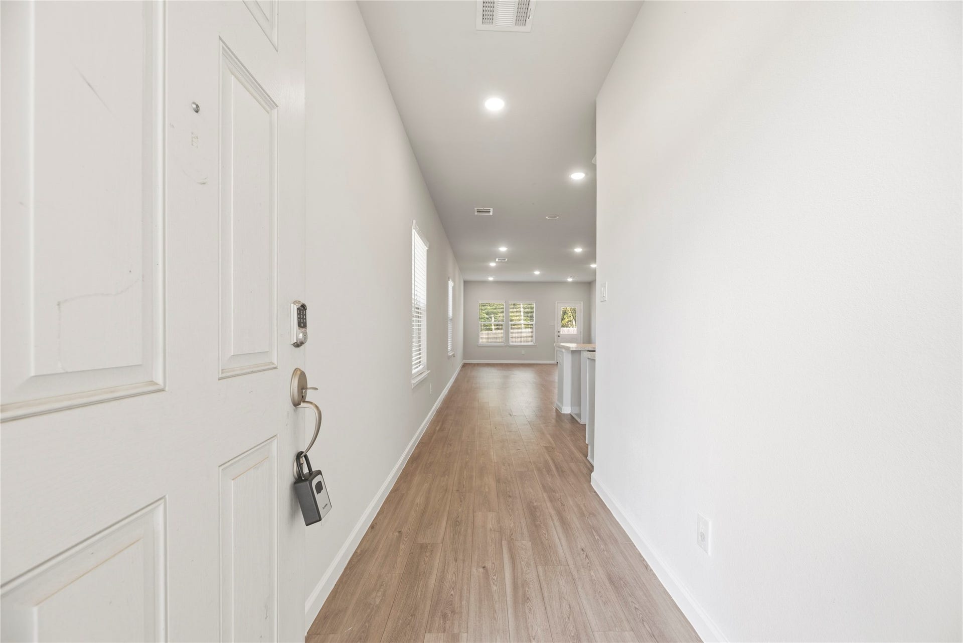16493 Moss Lane, Porter, TX 77365 Step inside to a long entry hall that opens toward the main gathering space. Wood-look flooring creates a continuous connection from the front door to the living area.