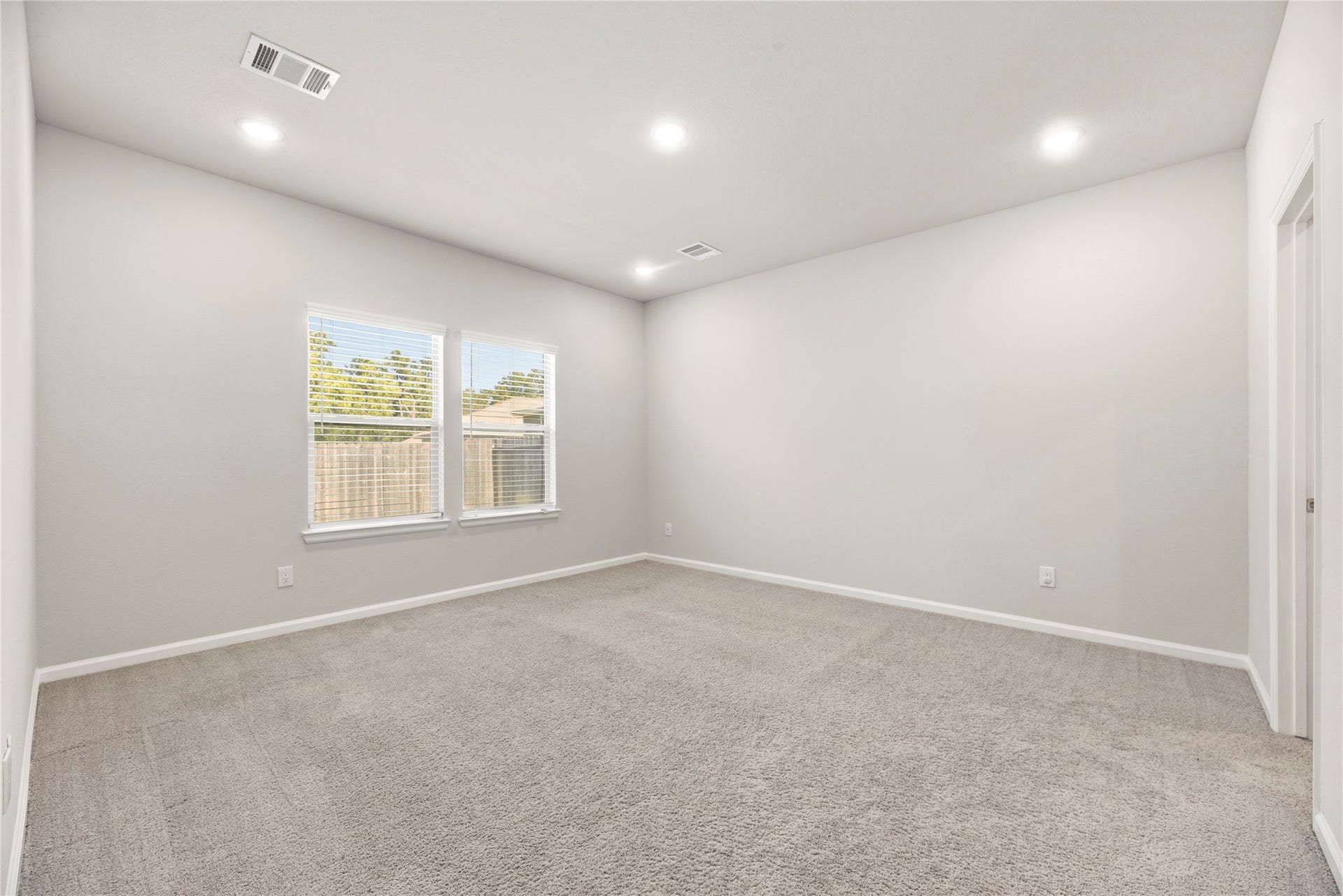 16493 Moss Lane, Porter, TX 77365 A soft neutral palette, carpet underfoot and natural light create a restful bedroom setting, ready for your own furniture and finishing touches.