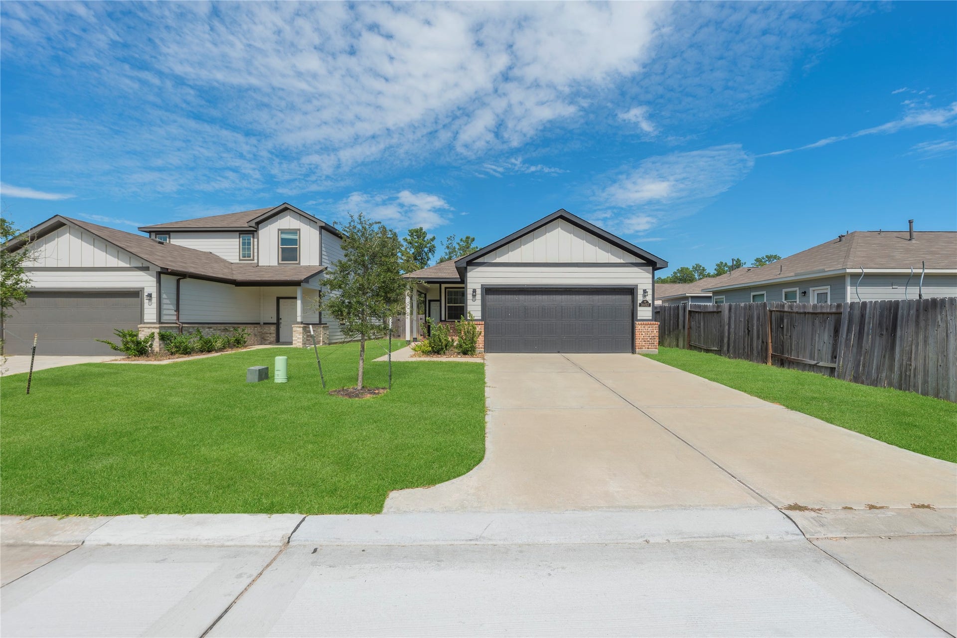 16493 Moss Lane, Porter, TX 77365 Set back from the street, the home pairs an open front lawn with a long driveway and a welcoming approach to the covered entry.