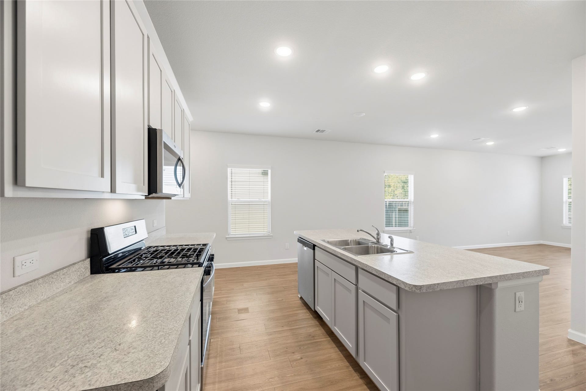 16493 Moss Lane, Porter, TX 77365 Prepare a meal while staying part of the conversation. The island faces the living area, giving the kitchen an open connection to the homes main gathering space.