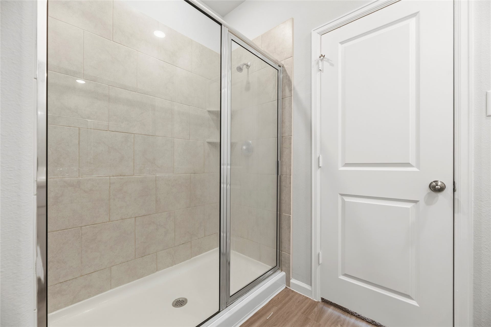 16493 Moss Lane, Porter, TX 77365 A glass-enclosed walk-in shower brings a clean-lined finish to the bathroom, with tile extending up the shower walls.