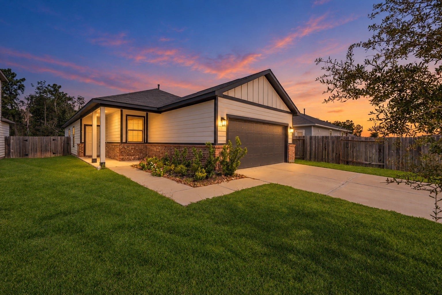 16493 Moss Lane, Porter, TX 77365 The covered entry and contrasting exterior finishes take on a warm evening glow in this digitally enhanced twilight view. Daytime exterior photos are also included.