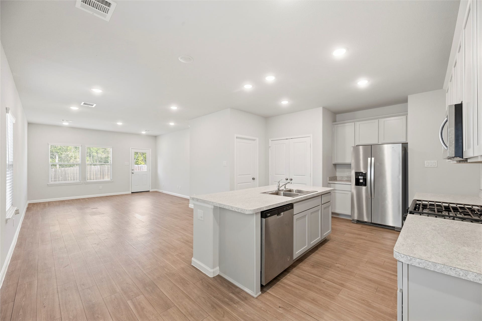 16493 Moss Lane, Porter, TX 77365 The kitchen and living area come together in one open gathering space, keeping conversation flowing whether you are preparing dinner or catching up with guests.