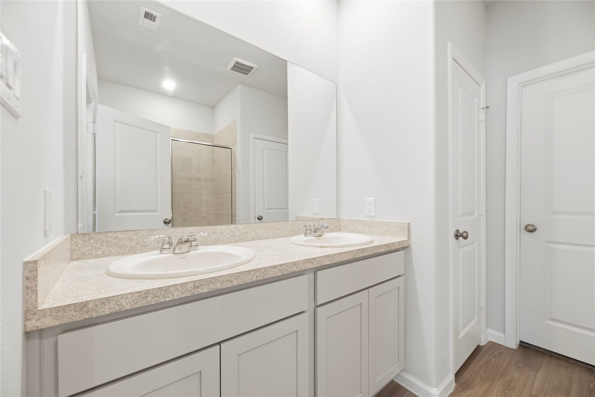 16493 Moss Lane, Porter, TX 77365 The bathroom vanity pairs counter space with cabinet storage to keep daily essentials close by, while the large mirror gives the space a bright, open feel.