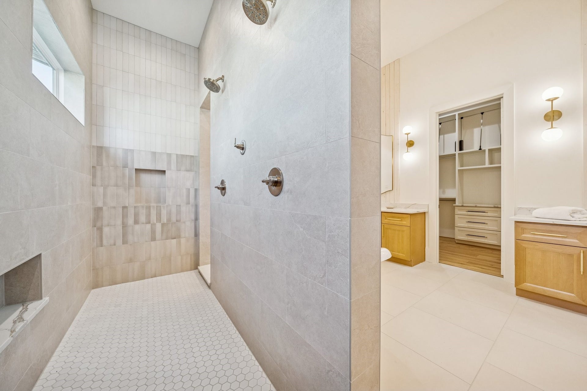 Double shower with built-in niches and subtle tile accents.