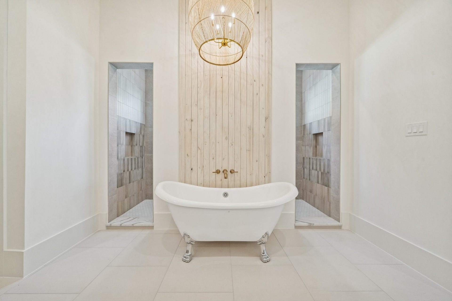 Clawfoot tub with a wall of shoji washed wood and an oversized accent light above. The shower is behind the wall.