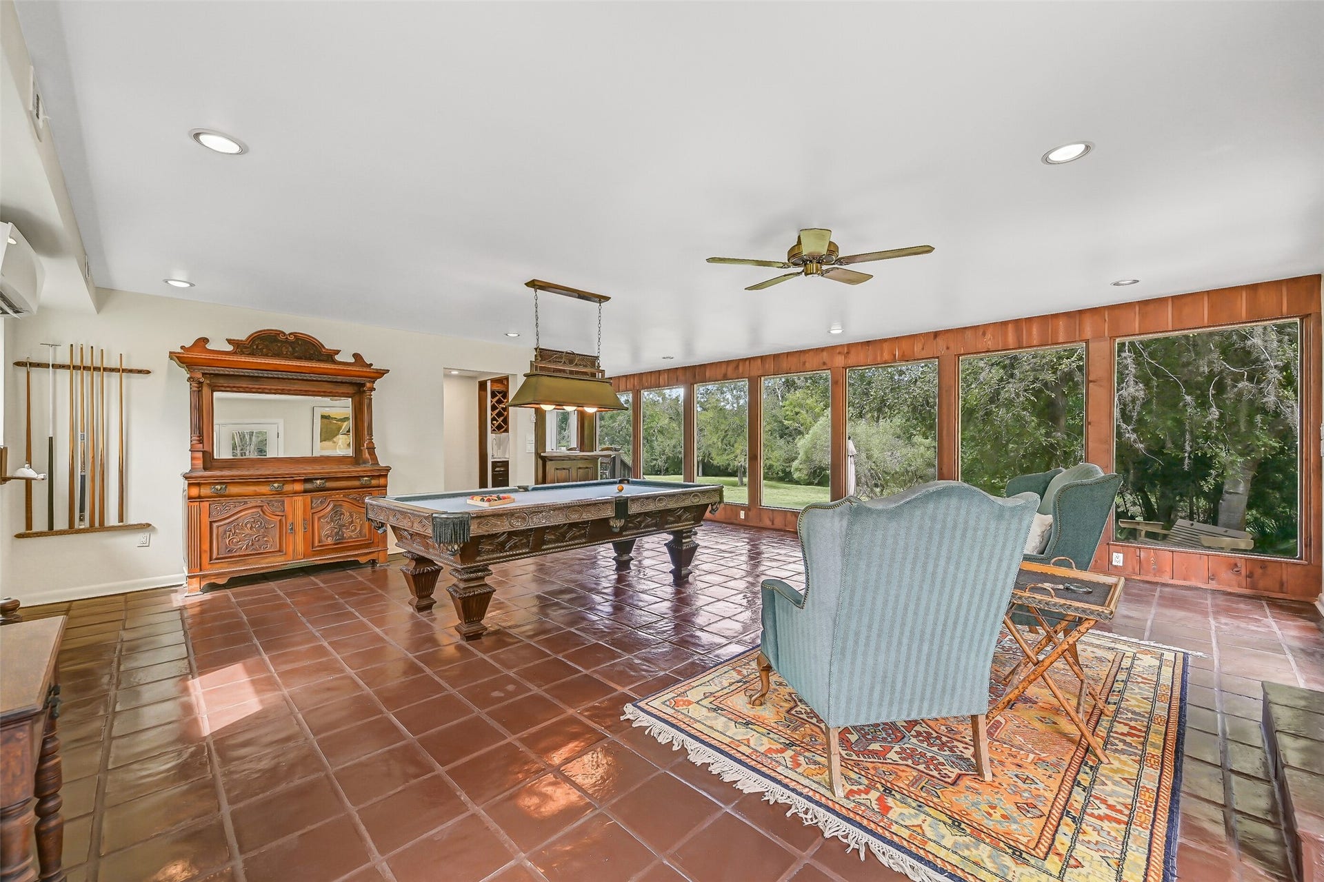 300 Courtlandt Place, Friendswood, TX 77546 This impressively sized gameroom provides abundant space for a full-sized pool table & separate sitting area. Painted tile flooring, recessed lighting, a ceiling fan & a wall of oversized picture windows overlooking the acreage complete this spacious addition.