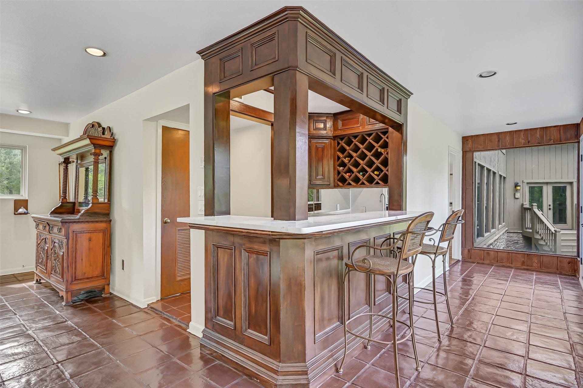 300 Courtlandt Place, Friendswood, TX 77546 Entering the expansive 23' x 23' gameroom, a custom wood wet bar welcomes you with rich paneled cabinetry, quartz-look countertops, built-in wine storage & bar seating. Complete with a sink & beverage refrigerator, this inviting gathering space is ideal for hosting friends & family.