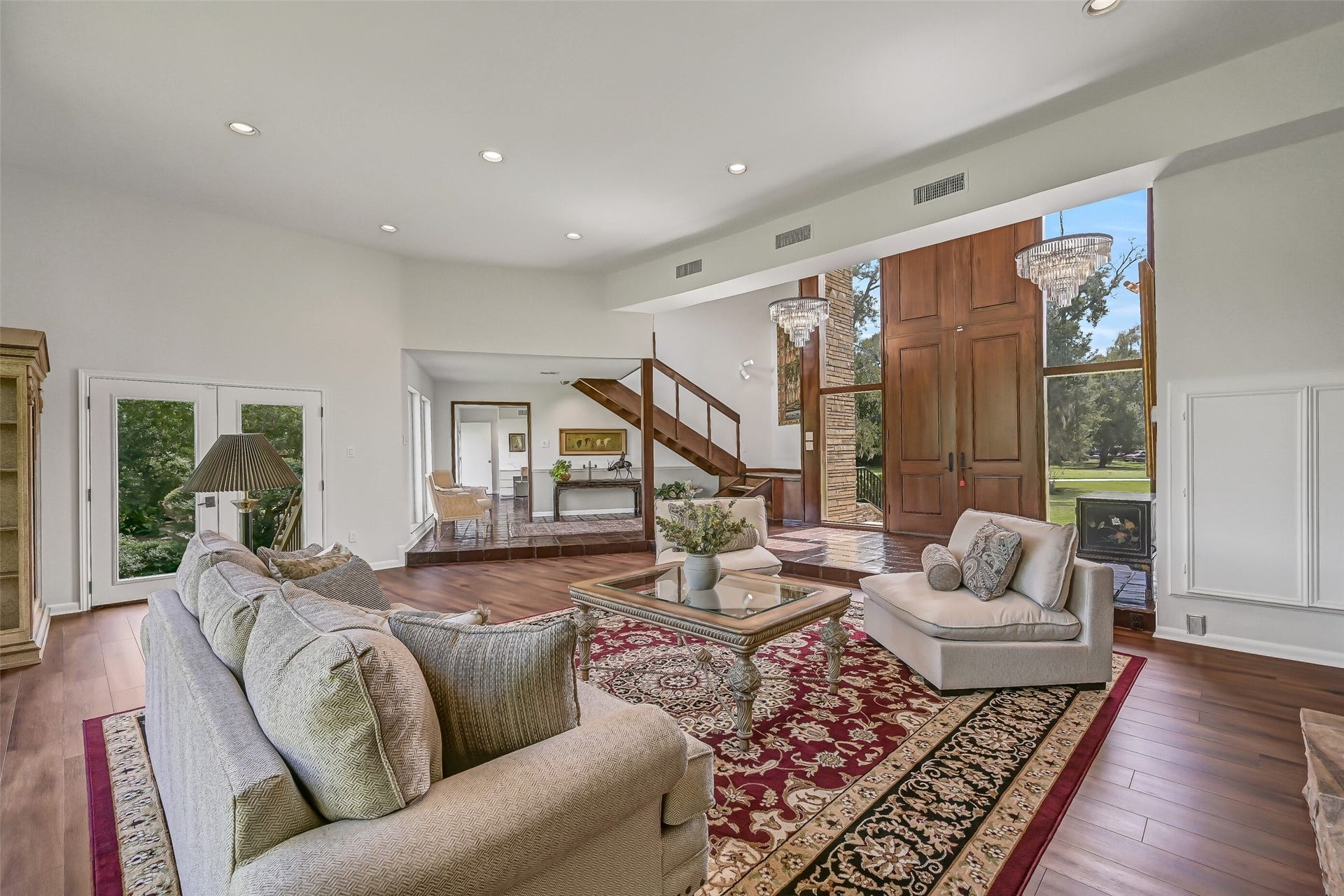 300 Courtlandt Place, Friendswood, TX 77546 The living room opens toward the home's grand entry, where the open-riser staircase and soaring ceiling create an interesting architectural contrast. With approximately 783 square feet, this generous gathering space offers abundant room for comfortable seating and entertaining.