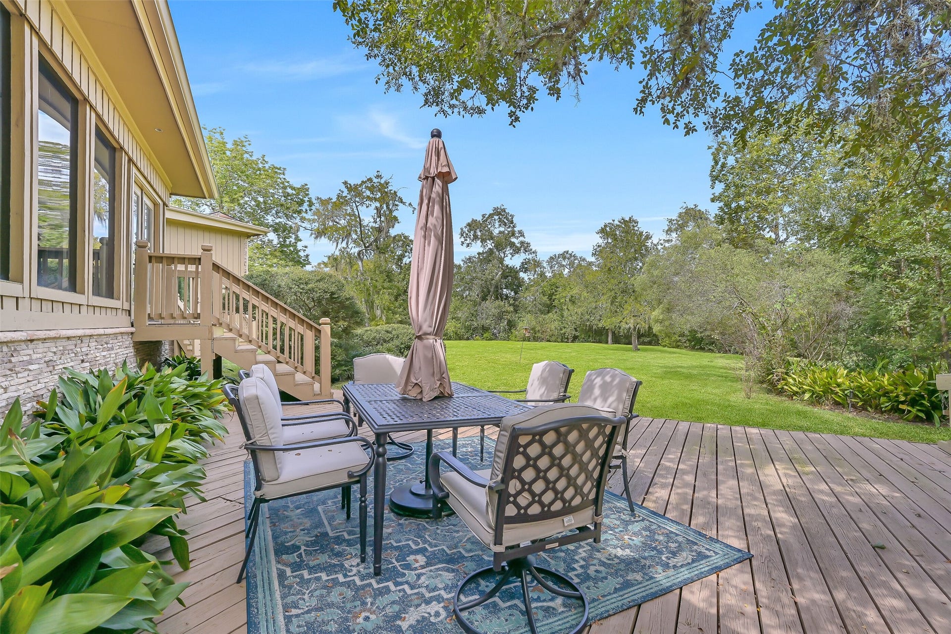 300 Courtlandt Place, Friendswood, TX 77546 Designed to take advantage of the beautiful surroundings, the spacious rear deck offers multiple areas for gathering, grilling or simply relaxing outdoors. A mature tree rises through a thoughtfully designed opening in the decking, adding to the character of this exceptional outdoor space.