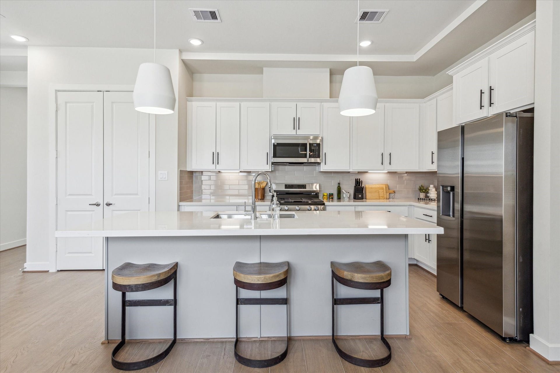 24405 Colonial Mound Drive, Katy, TX 77493 Representative photo showing the communitys model home kitchen. Layout and selections may vary.