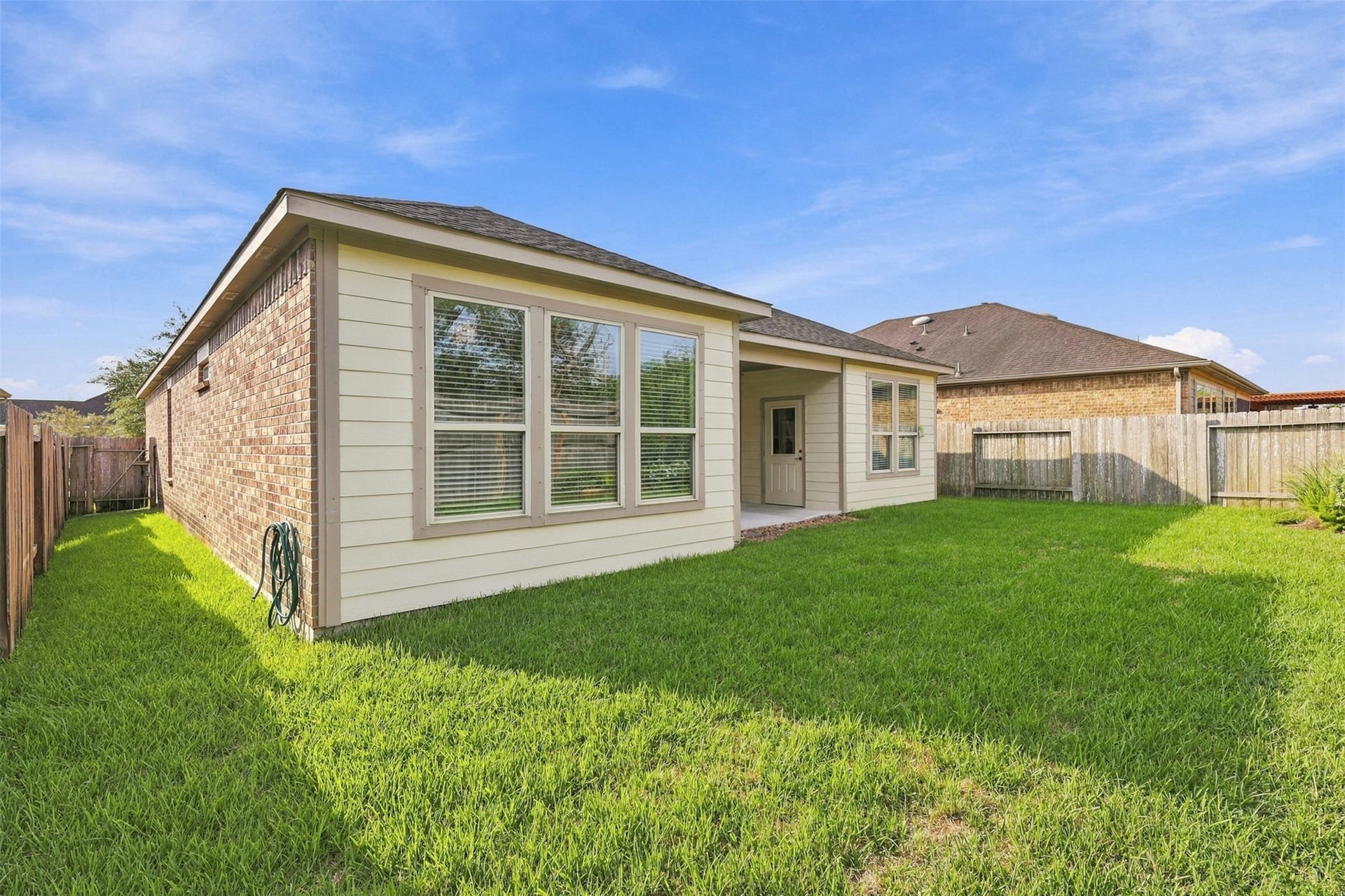 677 Tenuta Lane, League City, TX 77573 Covered patio and landscaped backyard.