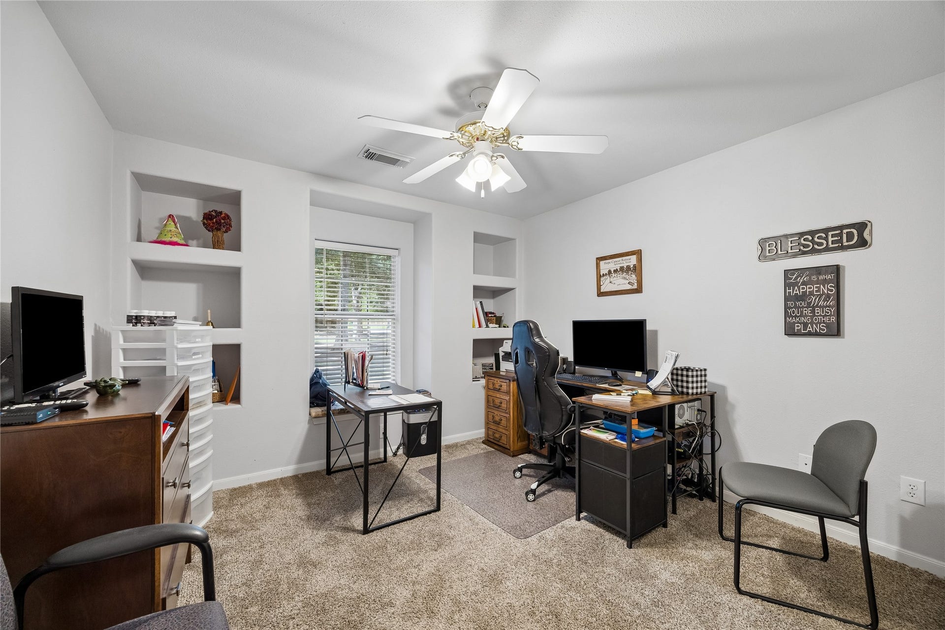 The second bedroom features a charming window seat and custom built-in shelving. Main Home